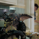 An evil Gremlin munches on a Christmas cookie in a scene from Gremlins.